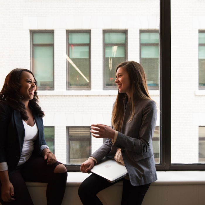 women sitting at window