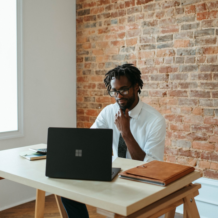 man sitting with laptop at table