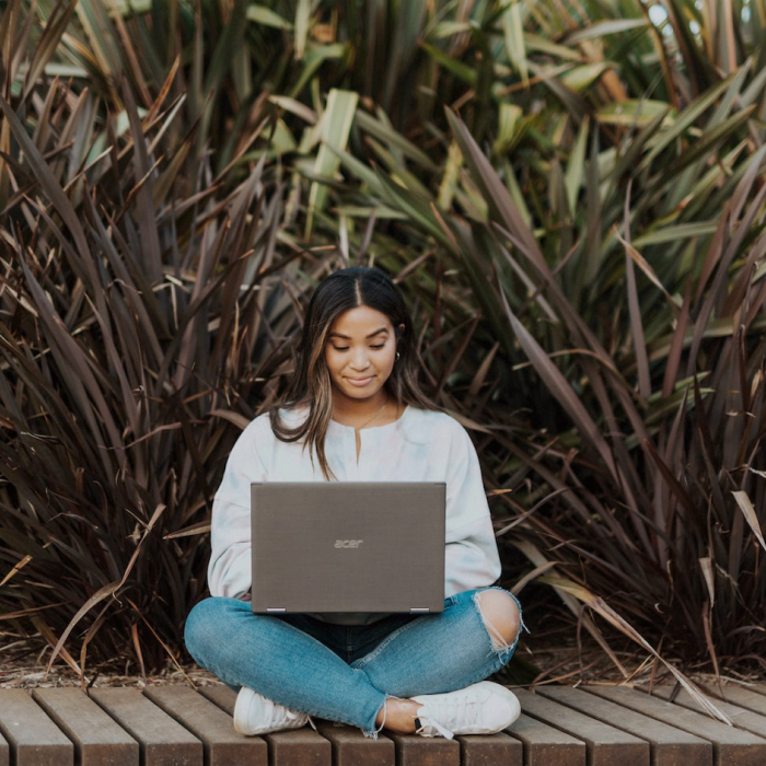 woman sitting outside with laptop