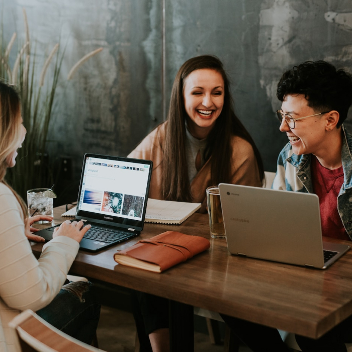 women at table with laptop